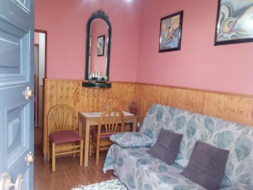 a living room with a couch and a table at Apartamento araceli in Chipiona