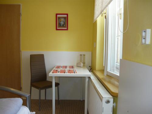 a small room with a table and a chair at Apartments - Penzion Lena in Hradec Králové