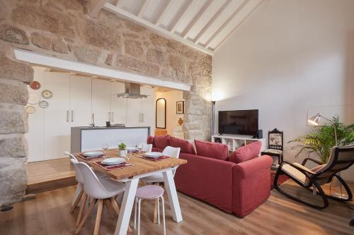 a living room with a red couch and a table at Maison214 in Vila Nova de Gaia