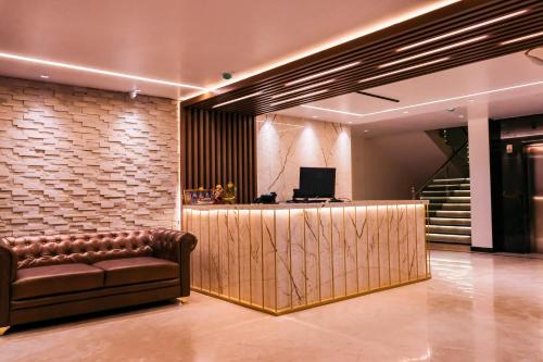 a lobby with a leather couch and a bar at Beyond Blu in Port Blair