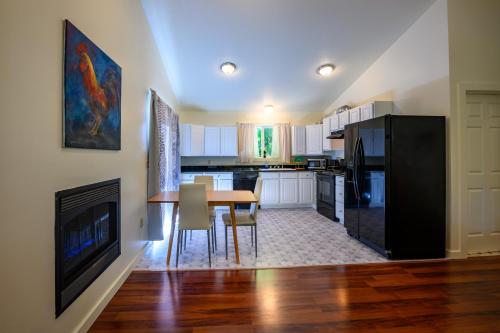 a kitchen and dining room with a table and a fireplace at Blue House - country living close to everything in Eugene