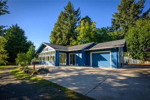 a blue house with a garage at Blue House - private 2 bed, 2 bath home with garage in Eugene