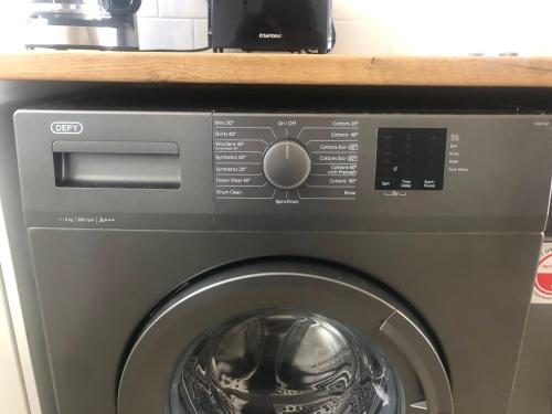 a washer and dryer with a microwave on a shelf at Bismarck 2 in Swakopmund