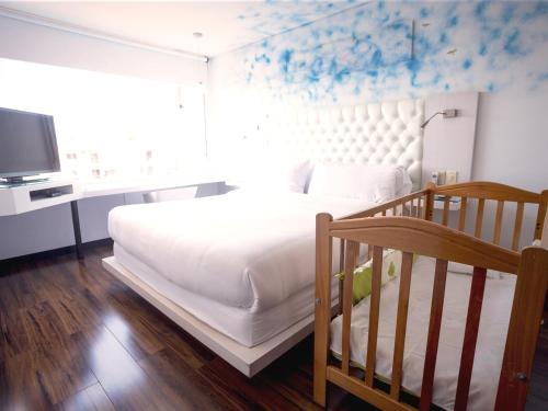 Un ou plusieurs lits dans un hébergement de l'établissement Hotel 104 Art Suites