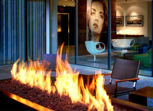 a large fire pit with two chairs and a table at The Hotel Zags Portland in Portland