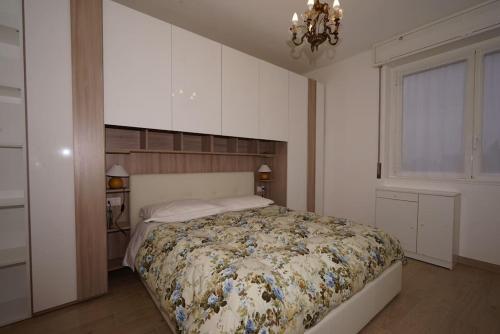 a bedroom with a bed and a chandelier at fiordaliso 1 in Milan
