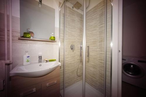 a bathroom with a sink and a glass shower at fiordaliso 1 in Milan