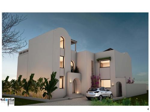 Villas Sophia في الحمامات: بيت ابيض فيه سياره متوقفه امامه