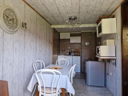 a kitchen with a table and chairs in a room at Cottage Kremna - Vila Kremna in Kremna