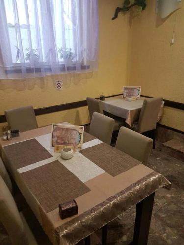 a dining room with two tables and chairs in a room at Apartments Bonus in Budva