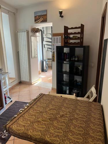 a living room with a table and a rug at Tuscia Home Backpackers in Orte