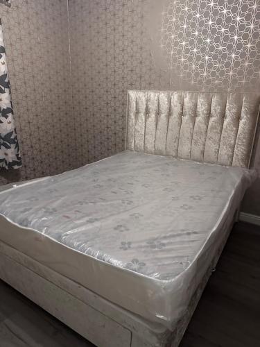 a bed in a room with a white mattress at Bobbys place in Barnsley