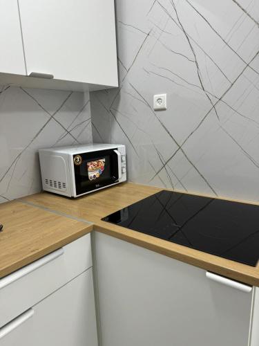 a toaster oven sitting on a counter in a kitchen at Квартира с новым ремонтом in Nahariyya