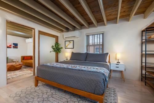 a bedroom with a bed and a living room at Casa Saint Francis- King Bed-Patio & Fire Pit -2BR in Santa Fe