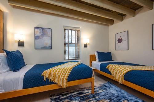 a bedroom with two beds and a window at Casa Saint Francis- King Bed-Patio & Fire Pit -2BR in Santa Fe