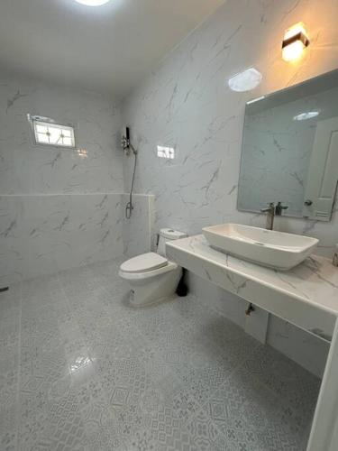 a bathroom with a sink and a toilet and a mirror at Pool villa copacolanta in Ko Lanta
