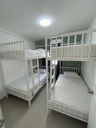 two white bunk beds in a small room at Pool villa copacolanta in Ko Lanta