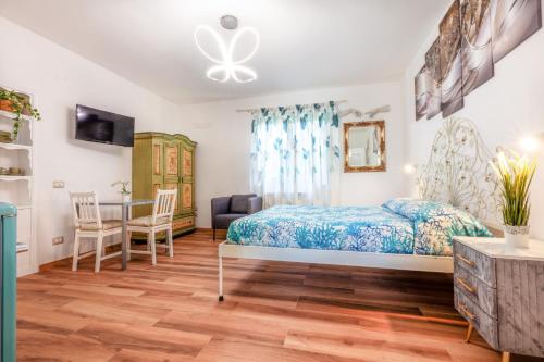 a bedroom with a bed and a desk and a table at Raggio di Sole in Massa Lubrense