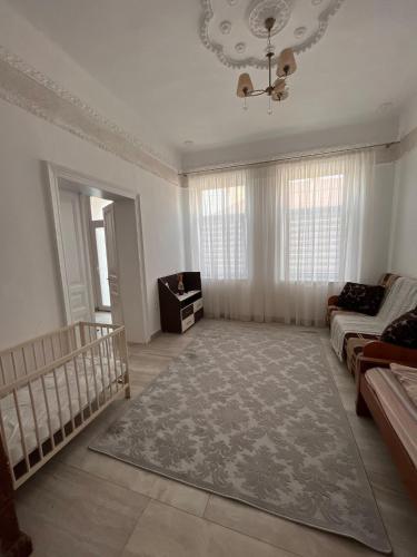 a large living room with a couch and a chandelier at casa buna 1 in Rădăuţi