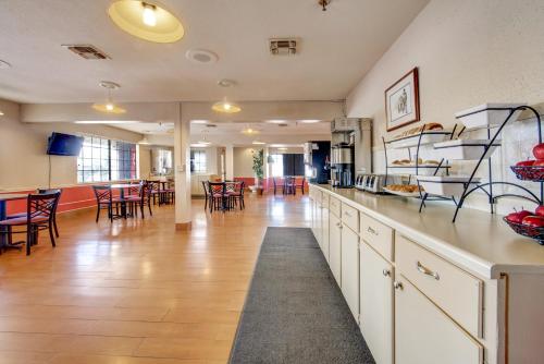 a large kitchen and dining room with tables and chairs at Days Inn by Wyndham College Station University Drive in College Station