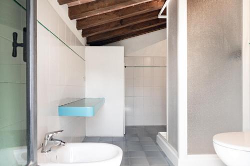 a bathroom with a sink and a toilet at Bolgheri Countryhouse in Bolgheri