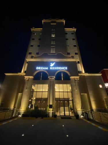 a building with a sign on the front of it at Dream Residence Rawabi in Al Khobar