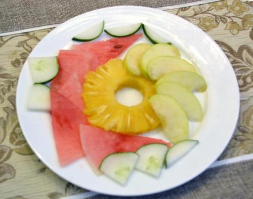 a plate of sliced fruit on a table at HP Pavilion in Abuja