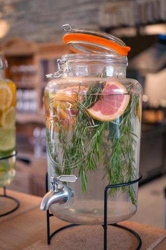 a jar filled with water with fruit and herbs at Le Domaine de Bra in Bra