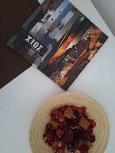 a bowl of food on a table next to a magazine at Vista Mare in Lagkáda