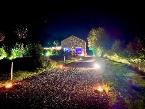 a night scene of a house with lights on a road at Le Domaine de Bra in Bra