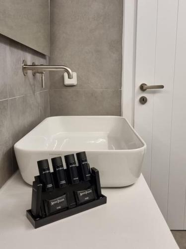 a white bath tub sitting on a counter in a bathroom at Màrgaros House Tinos in Triandáros