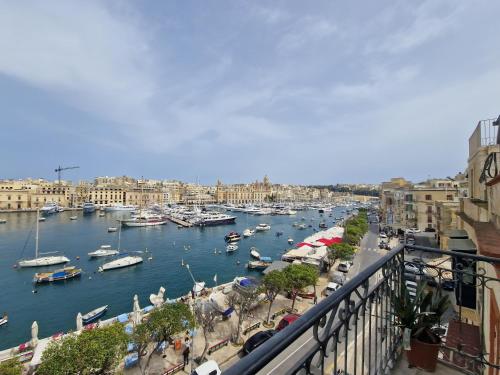 a view of a harbor with boats in the water at KORZO SUITES SENGLEA WATERFRONT in Senglea