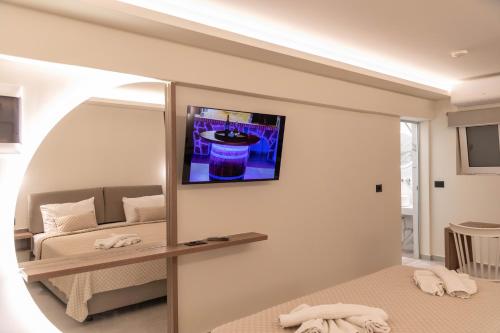 a room with a mirror and a bed and a couch at Missiria Apartments in Rethymno Town
