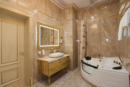 a bathroom with a tub and a sink at "Bogishamol Gavhari" ООО in Andijan