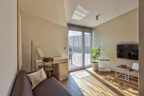 a living room with a couch and a desk at 714 Mugnano House Aveleda in Vila do Conde
