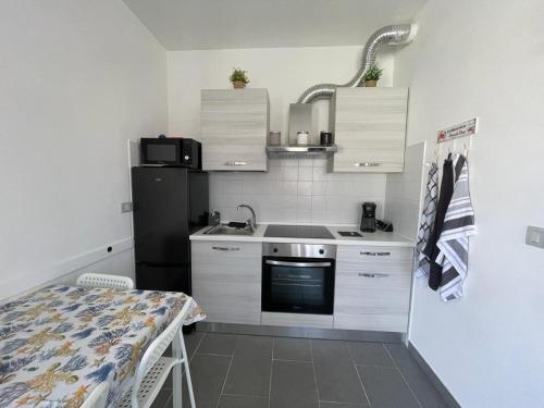 a small kitchen with a sink and a refrigerator at Casa Porto San Rocco in Marina di Grosseto