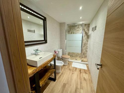 a bathroom with a sink and a toilet and a mirror at SOLGUEST Apt ESTEPONA CENTRO 1ª LINEA DE PLAYA in Estepona