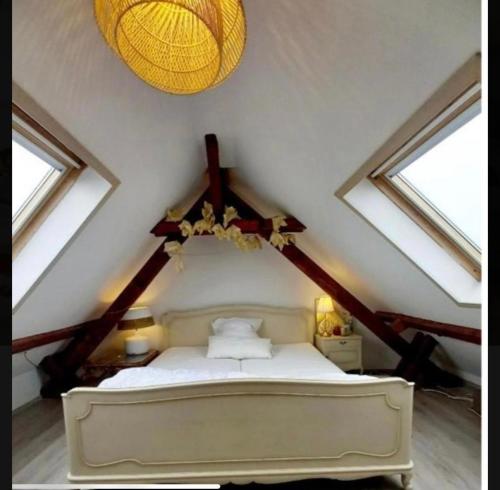 a bedroom with a white bed in a attic at Loft Düsseldorf City in Düsseldorf