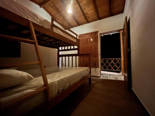 a bedroom with two bunk beds and a window at Cabaña El Cangrejo Azul - Blue Crab House in San Onofre