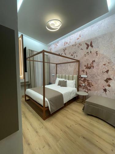 a bedroom with a bed and a wall with butterflies at Hotel Central Giacomini in Salò