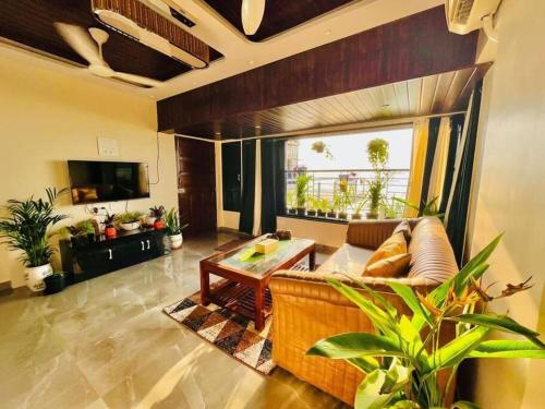 a living room with a couch and a table at sea view apartment in Juhu in Mumbai