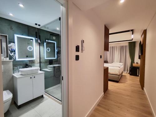 a bathroom with a shower and a sink and a toilet at AMD Premium rooms Budva in Budva