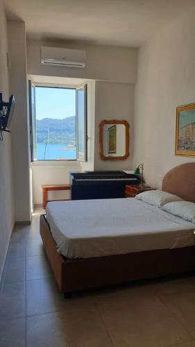 a bedroom with a large bed and a window at Cà dela Fanteleta in Portovenere