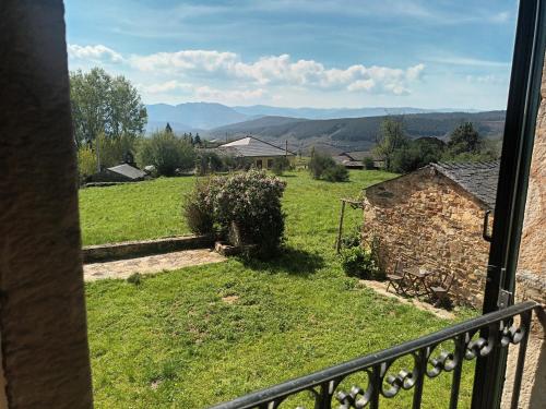 a view of a green field from a balcony at Palacio de Cantiz "Reserva de Ancares" in Becerreá