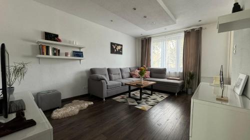 a living room with a couch and a table at Milde's apartment near the city center - Hospodarska street in Trnava