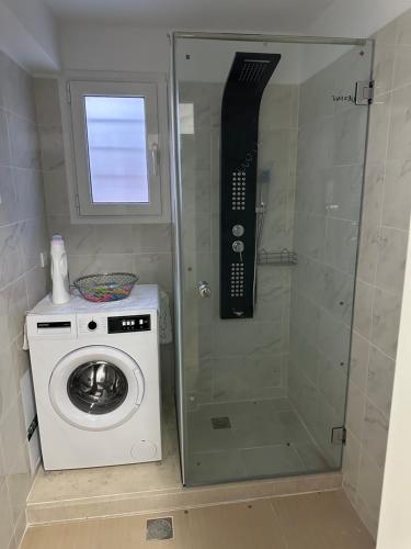 a shower with a washing machine in a bathroom at Villa Daniela in Loutraki