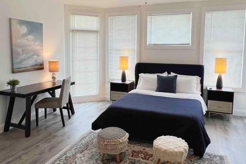 a bedroom with a bed and a table and a desk at Brickell + Wynwood Wonderland: Spacious 6BR Home in Miami