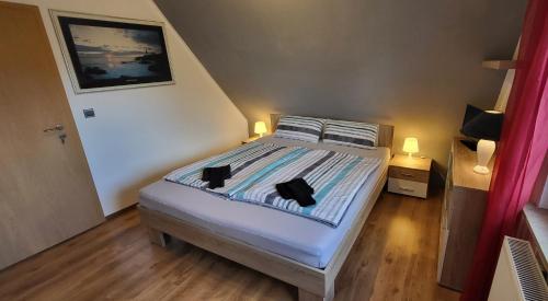 a bedroom with a bed with two pillows on it at Privates Doppelzimmer bei der Weser-Ems Halle in Oldenburg
