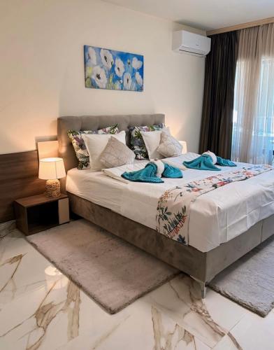 a bedroom with a large bed with blue towels on it at Sea Garden Beach Studio in Saints Constantine and Helena