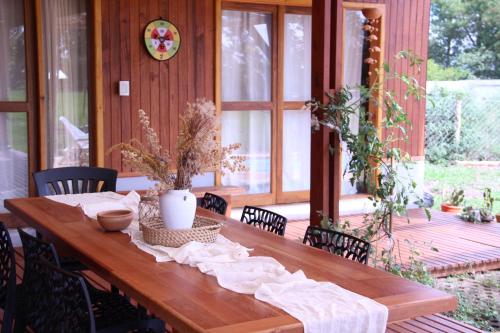 a wooden table with a table cloth on a porch at Akeka la casa del lago in Candelaria